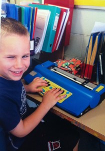 boy with braille machine